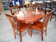A circular dining table and 4 chairs