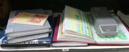 A quantity of folios containing watercolours, an art set,