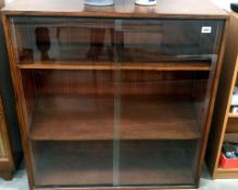 A bookcase with glass sliding doors