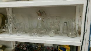A shelf of glassware inluding claret jug & vases etc.