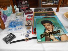 A collection of Elvis Presley memorabelia including car, key ring & books etc.