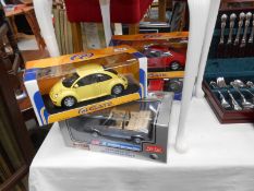 Five 1.18 scale boxed model cars including Revell & Anson etc.