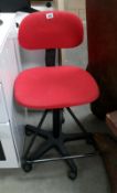 A red swivel office chair