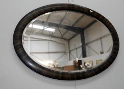 An oval bevel edge mirror