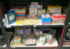 2 shelves of Rupert the Bear books and VHS videos