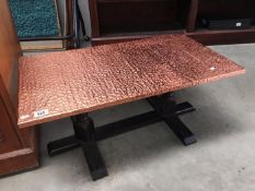 A copper top coffee table