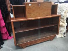 A 1940's/50's display cabinet with glass sliding doors