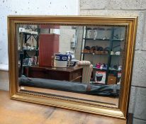 A bevel edged mirror in gilt frame