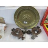 A pair of arts and crafts candleholders and a brass plaque