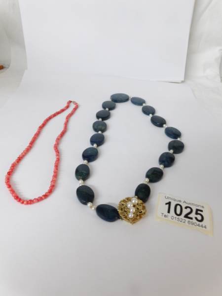 A good 'Blue John' stone necklace with 14kt gold and pearl set clasp together with a coral necklace