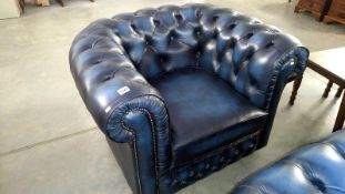 A blue leather Chesterfield style arm chair