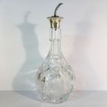 A silver topped cut glass wine decanter