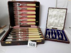 A cased set of 6 cake knives and a cased set of fish knives and forks