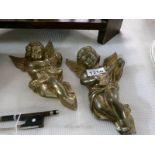 A pair of brass cherubs