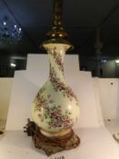 A 1930's porcelain and gilt metal table lamp