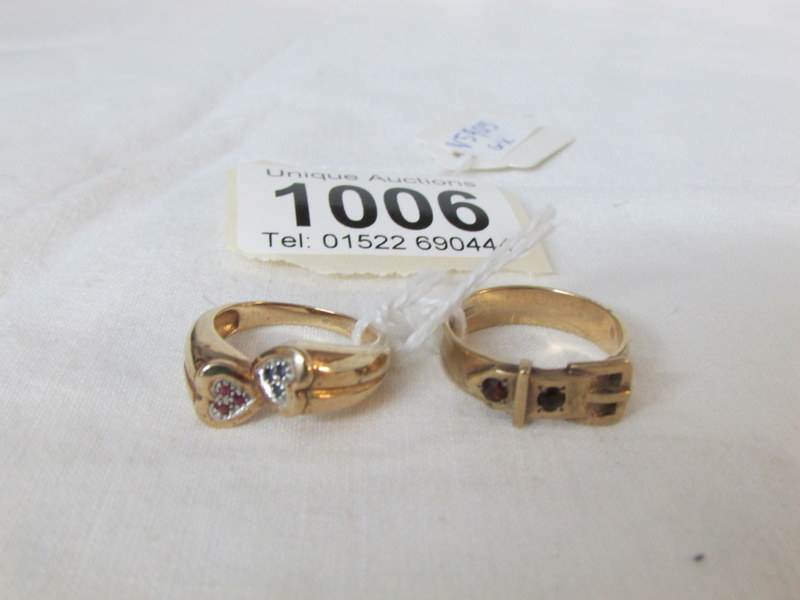 A 9ct gold buckle ring and a 9ct gold cross over ring,