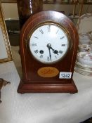 A mahogany inlaid mantel clock