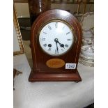 A mahogany inlaid mantel clock