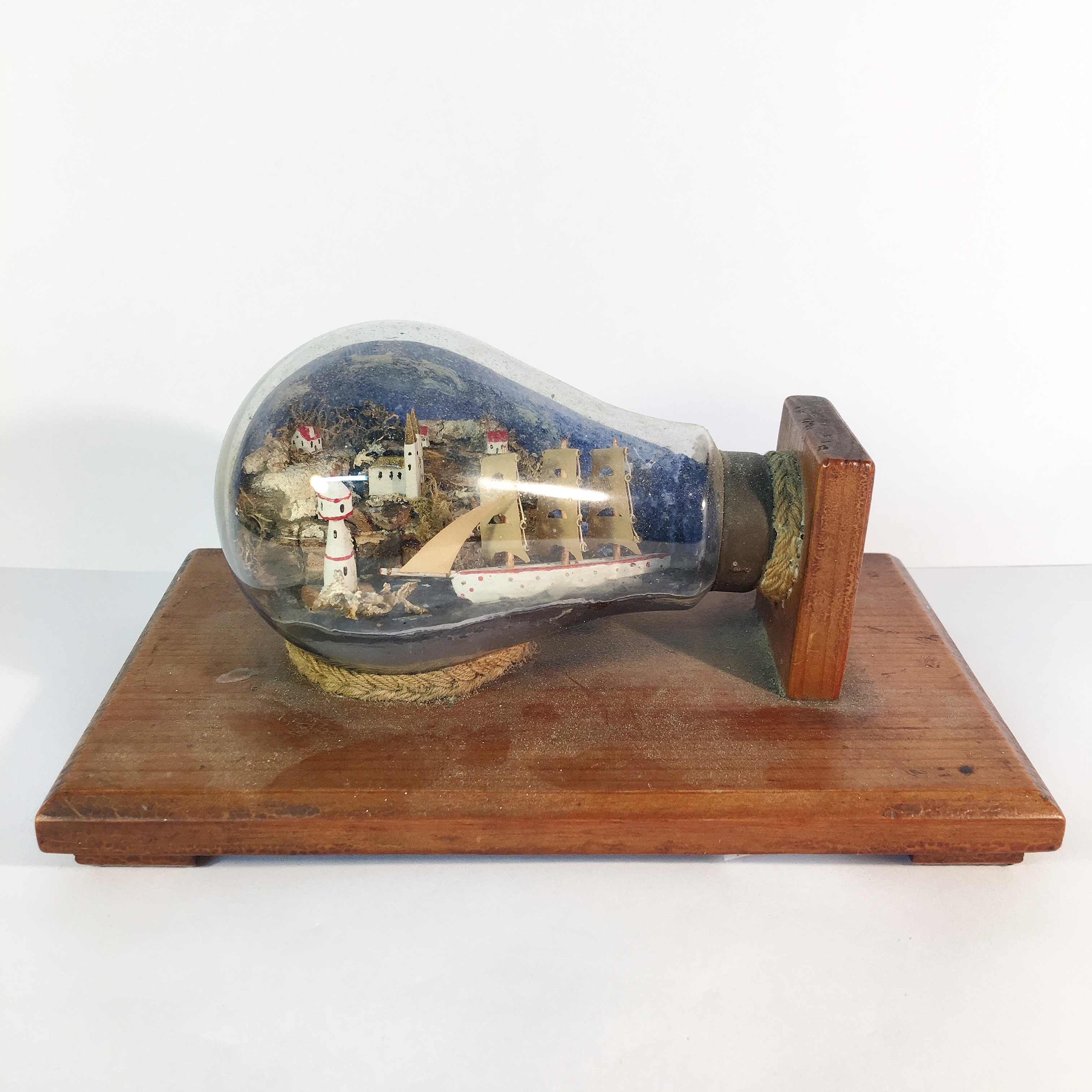 A miniature coastal scene in a light bulb made by a German prisoner of war at POW camp Stratford