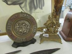 An oriental brass plaque and one other item