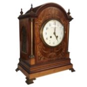A mahogany inlaid mantel clock, dial inscribed S. Smith & Son Ltd., 104, Strand, London.