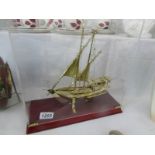 A cased fine quality brass model yacht