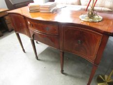 A mahogany inlaid serpentine front sideboard