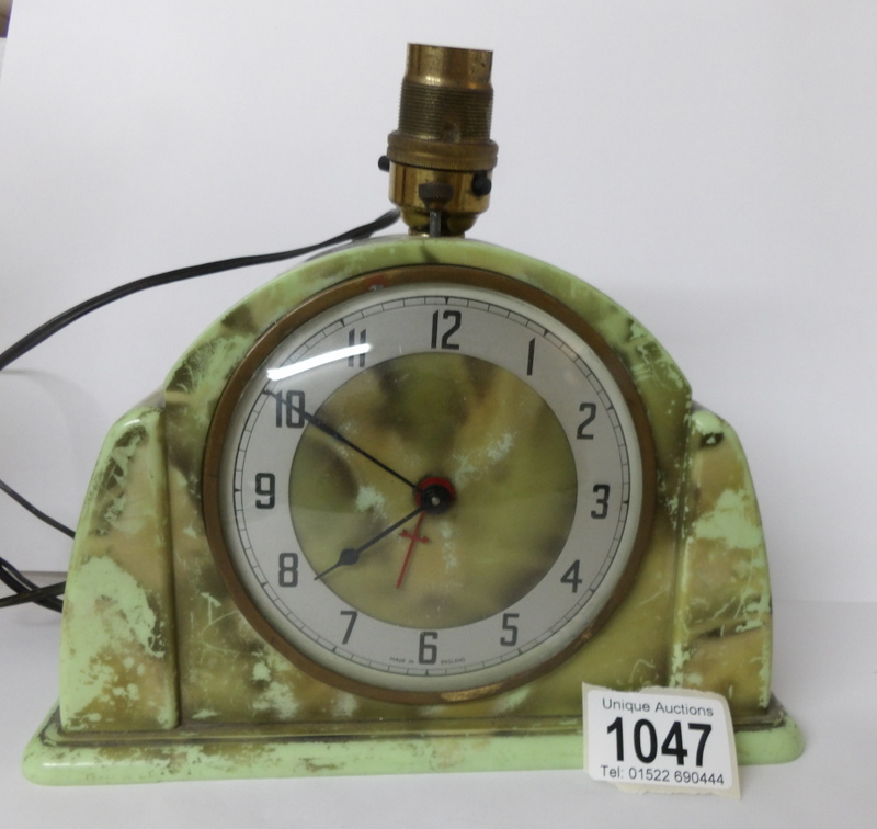 An Art Deco green bakelite Metamec electric clock/lamp