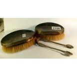 2 silver backed brushes and a pair of silver sugar nips