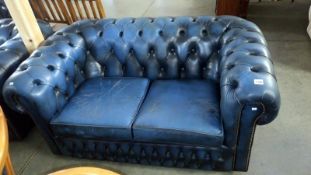 A blue leather 2 seater Chesterfield sofa