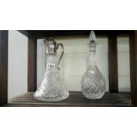 A cut glass decanter and claret jug