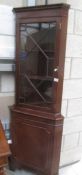 A mahogany astragal glazed corner cabinet