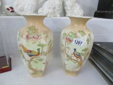 A pair of Ducal bird decorated vases