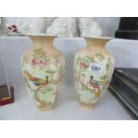 A pair of Ducal bird decorated vases