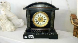 A wooden palladian style mantel clock