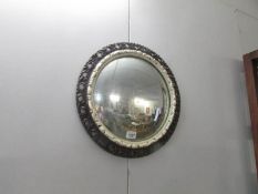 A circular convex wall mirror