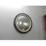 A circular convex wall mirror