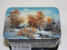 A hand painted and signed Russian lacquered box with winter scene