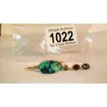 A pair of gold stud earrings set garnet and a natural turquoise stone formed in to a brooch with