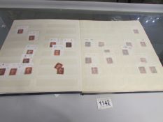 A stock book of over 100 British penny red stamps including envelopes