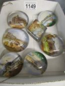 A quantity of souvenir paperweights