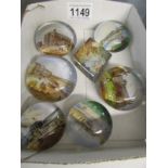 A quantity of souvenir paperweights