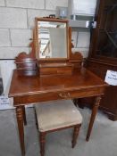 A mahogany dressing table and stool