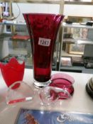 A tall cranberry glass vase, a smaller example,