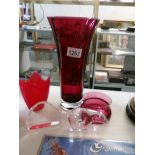 A tall cranberry glass vase, a smaller example,