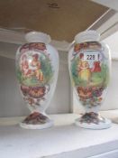 A pair of opaque glass hand painted vases