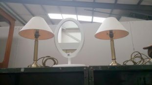 A pair of table lamps and a mirror