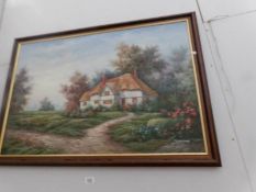 A framed oil on canvas thatched cottage scene signed Marten