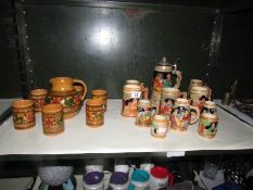 A quantity of German beer steins together with hand made jug and beakers