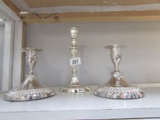 A pair of silver plate candlesticks and one other